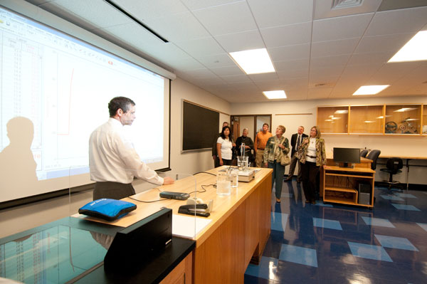 Joseph E. Leblanc, instructor of physics, shares scientific insights with a tour group.  