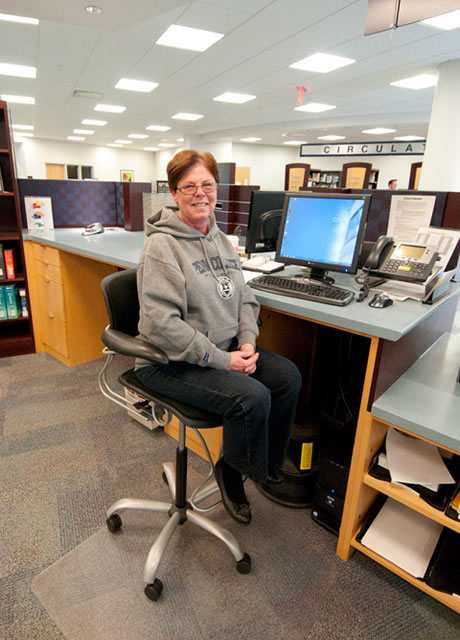 Operations assistant Linda Szuhaj displays her Penn College Pride at the Madigan Library reference desk Friday.