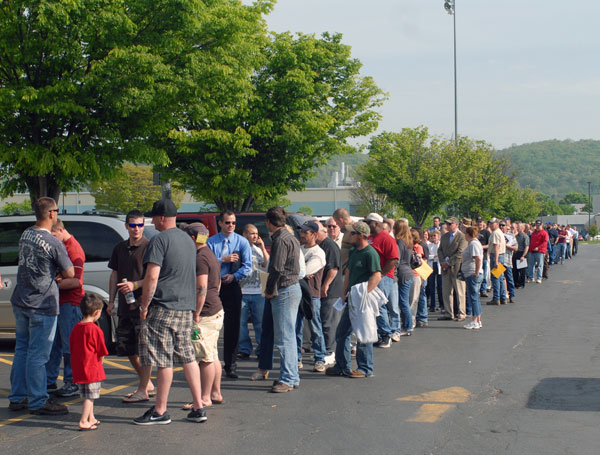 A line of job-seekers stretches from the Field House entrance and across the parking lot.