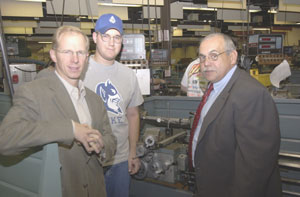 From left are Ian Walsh, vice president and general manager of Lycoming Engines%3B student Frank G. Simko, Wyalusing%3B and Donald O. Praster, assistant dean of industrial and engineering technologies, in a machining lab at Pennsylvania College of Technology. Simko is among students using some of the %2440,000 worth of raw materials donated by Lycoming Engines to the College.