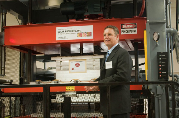 Mark Strachan, president of Global Thermoforming Training Inc., describes the technical details of a hybrid thermoforming machine  a one-of-a-kind piece of equipment  in the colleges new Thermoforming Center of Excellence.