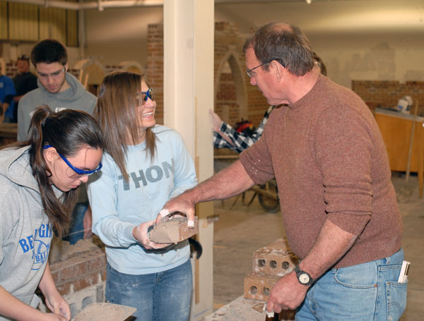 Richard R. Motter, instructor of building construction at Penn College, elicits a smile from a fast-learning architecture student.