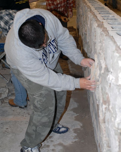A visiting Penn Stater fashions a fit onto a natural-stone facade.