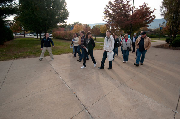 Student Ambassador Megan R. Pennington briskly crosses campus with a tour group.