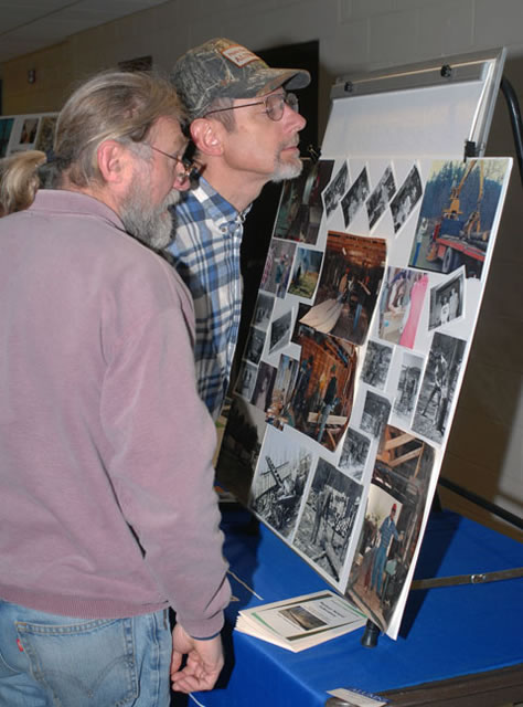 Alumni look at old photos, yearbooks and other memorabilia during a lunch break in the Nature's Cove dining hall.