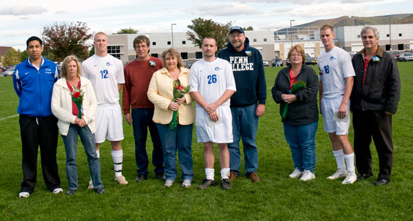 Three senior members of the Wildcat men's soccer team also were honored. From left are coach Enrique Castillo; Derek Geisinger (12), with parents Michelle and Karl; Brendan Muth (26), with parents Sue and Dean; and Steven Bullock, with parents Elizabeth and Brad.