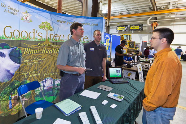 Erich R. Doebler, a laboratory assistant for forest technology, checks in with Bob Good, left, and 1982 nursery management graduate Aaron M. Shippling at the Good's Tree Care Inc. booth.