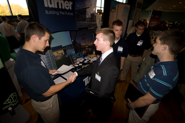 Construction management student Alex Eberly shakes the hand of Jason Smeltzer, a 2006 graduate of the same program, now an employee of (and recruiter for) Turner Construction Co.