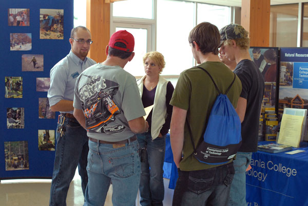 Alumnus Micah A. Metzel, whose multiple degrees include diesel technology and heavy construction equipment technology: technician emphasis, shares his insight with Open House guests.