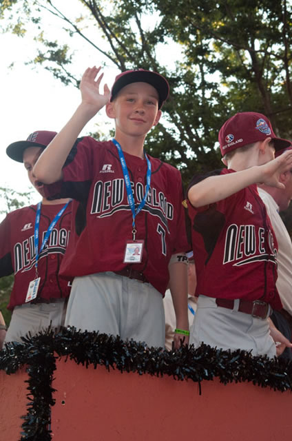 The New England team from Fairfield American Little League in Connecticut returns waves at the Grand Slam Parade.