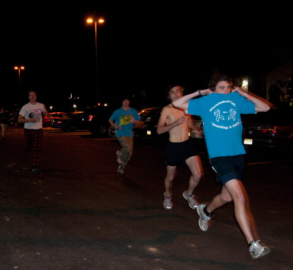 In an event that was both fun AND functional, a participant in Thursday's "Nearly Naked Mile" sheds his shirt for charity. The race attracted about 35 runners, who filled two large bins with clothing donations for the American Rescue Workers.