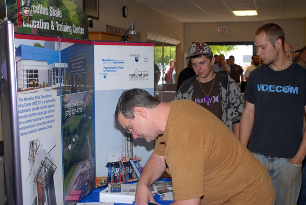 Expo attendees sign in at the Marcellus Shale Education & Training Center table.