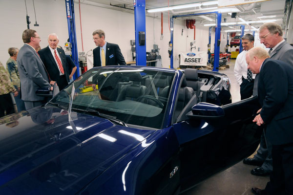 College officials and guests gather around a 2011 Ford Mustang convertible, the 137th vehicle in the School of Transportation Technology's fleet.