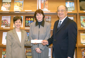 Joann M. Kay, executive director of the Penn College Foundation, receives a scholarship check from Dr. Wayne A. Longbrake, dean of natural resources management%3B and Dr. Mary A. Sullivan, assistant dean, in the library of the Schneebeli Earth Science Center.