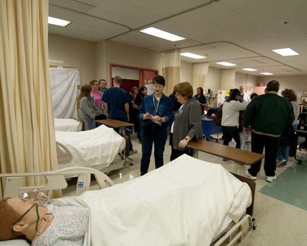 Visitors crowd into the School of Health Sciences' nursing lab.