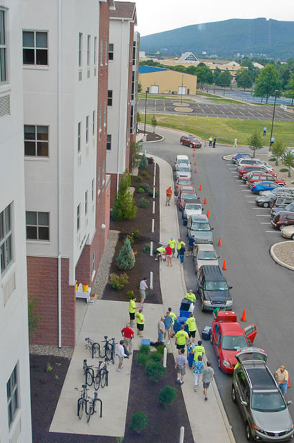 Move-in crews make quick (and orderly) work of unloading vehicles at Dauphin Hall, as seen in this view from above.