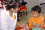Paramedic Learning Lab Coordinator Bambi Hawkins attaches a meter to a child's finger