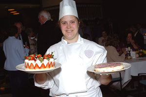 Baking and pastry arts student Alicia Shaull of York County brings fresh cakes to replenish the pastry buffet.