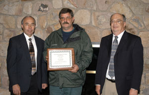 Scott B. Appleman, instructor of diesel equipment technology, (center) is flanked by Philip Finet, chairman of the Caterpillar Excellence Fund (left)%3B and Dr. Wayne R. Longbrake, dean of natural resources management at Penn College.