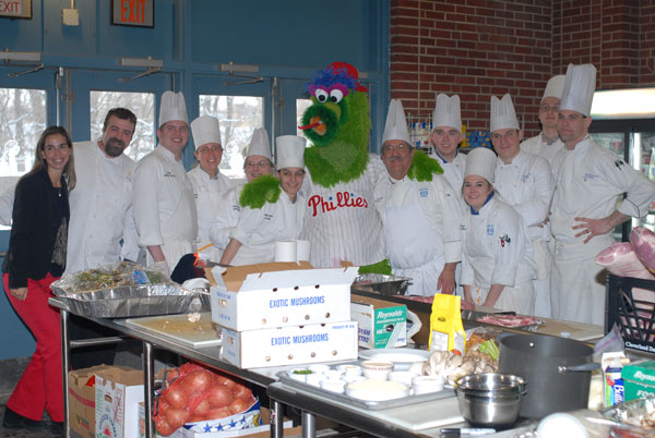 Hospitality students, faculty and Farm Show friends gather 'round the Phillie Phanatic during a welcome break on a busy day of kitchen wizardry.