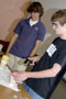 Students mix chemicals to create a polymer during an experiment