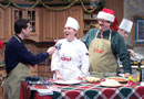 Tom Speicher interviews student Yolanda T. Rauwendaal, as Chef Paul Mach (in Santa hat) shares a laugh and student Timothy C. Wright works in the background