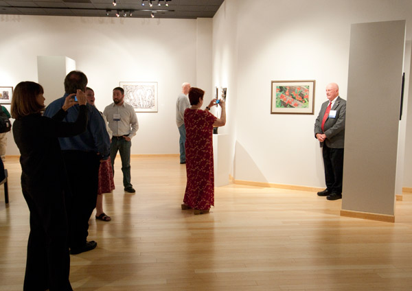Photographers line up for a portrait of the artist, 1941 Williamsport Technical Institute graduate Raymond Eck.