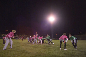 Action under the lights at Sunday's 'Powder Puff Football' game. (Photo by Phillip C. Warner, student writer-photographer)