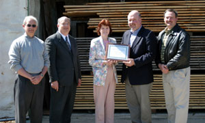 Reaffirming a successful partnership are, from left, Dennis F. Ringling, forestry professor%3B Wayne R. Longbrake, dean of natural resources management%3B Mary A. Sullivan, assistant dean of natural resources management%3B Paul Wirth, PPL's corporate communications manager%3B and Kevin R. Drewencki, superintendent of PPL's Montour Preserve. The group toured the Schneebeli Earth Science Center %96 including this lumber-drying kiln near the center's working sawmill %96 as well as Penn College's main campus. 