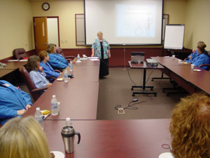 A group of PRIMUS Technologies Inc. employees gathers in a WDCE classroom as part of a companywide communications-training initiative. (Photo by Dan R. Rockwell, workforce development consultant)