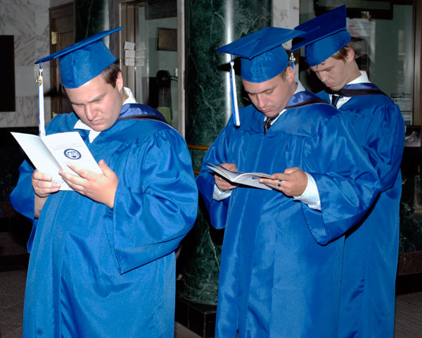 En route to the day's proceedings, students browse the official program.