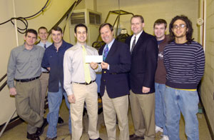 From left, Kevin M. Vanderbeck, Penn College Society of Manufacturing Engineers student chapter member%3B Alan J. Wertz, Penn College SME president%3B John G. Upcraft, Penn College SME faculty adviser%3B Christopher A. Hunter, Penn College SME vice president and Mini Baja team captain%3B John Terefencko, R%26T Technologies president%3B Mike Reed, R%26T Technologies vice president of operations%3B Zachariah J. Thull, Penn College SME member%3B and Zachary R. Mazur, Penn College SME member and Mini Baja fabrication team head.