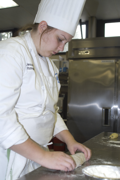 Baking and pastry arts student Jessica Kitzmiller portions raisin bread dough. 