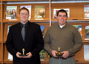 Stephen R. Ganser, left, and Bryan T. Farney display their Rodeo trophies in the Earth Science Center library.