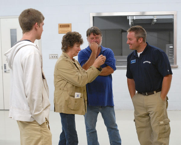 Welding instructor Ryan P. Good, right, shares a light moment with MTC visitors.