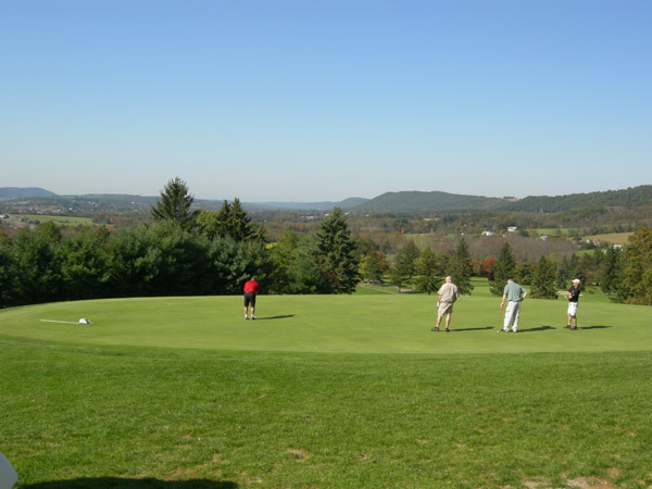 The rolling hills of northcentral Pennsylvania frame a foursome that includes Harland Bergstrom, a 1977 graduate in electronics technology.