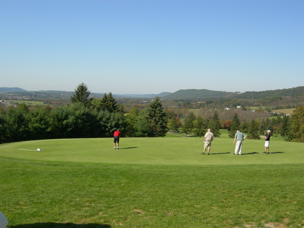 The rolling hills of northcentral Pennsylvania frame a foursome that includes Harland Bergstrom, a 1977 graduate in electronics technology.