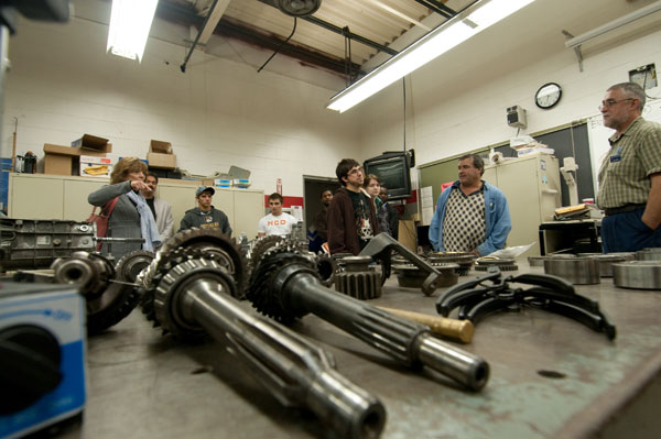 William H. Schaefer, assistant professor of automotive technology (right), prepares to answer a mother's question.
