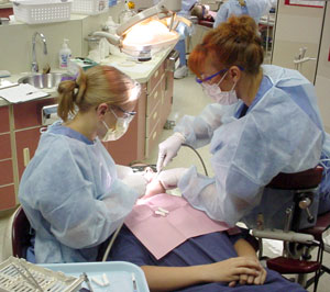 Dental hygiene students apply sealants to one of the 32 children who participated.