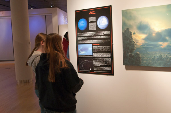 Girls explore an artists rendering of Neptunes surface during An Extraordinary View of the Solar System in The Gallery at Penn College.