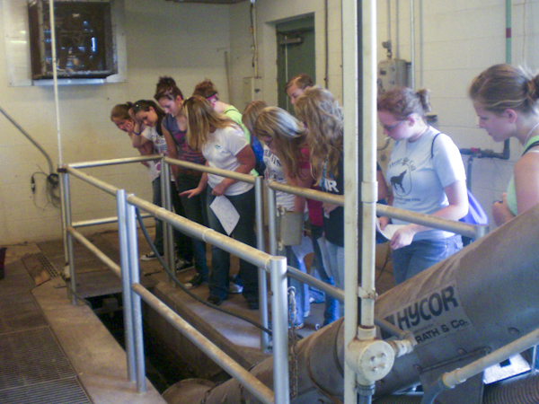 During a field trip, girls get an overhead view of raw sewage entering a treatment plant. 