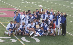 Wildcat men's soccer team holds its third consecutive championship trophy at midfield Sunday.