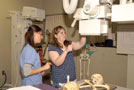 Allison M. Kruzik, a radiography major from Lansford (left), instructs a visitor to the School of Health Sciences