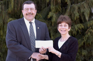 Paul H. Rooney Jr., senior vice president and regional president for Sovereign Bank, presents a check to Joann Kay, executive director of the Pennsylvania College of Technology Foundation.