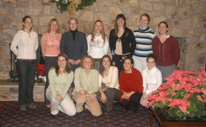 Dr. Gilmour joins the women's volleyball coach and players in the PDC.