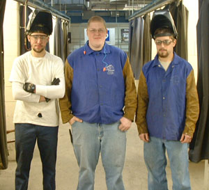 From left, Michael T. Olewnik, Michael A. St.George, and Kade E. Poorman built the Dutch oven table.