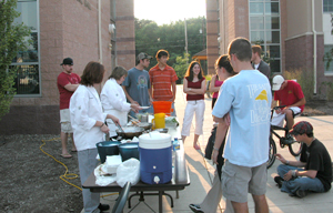 Chef Suzann L. Major (third from left) and student Christine L. Faherty (second from left) prepare salads for First-Year Experience students at Rose Street Apartments. (Photo by Darya A. Rotblat, coordinator of residence life)