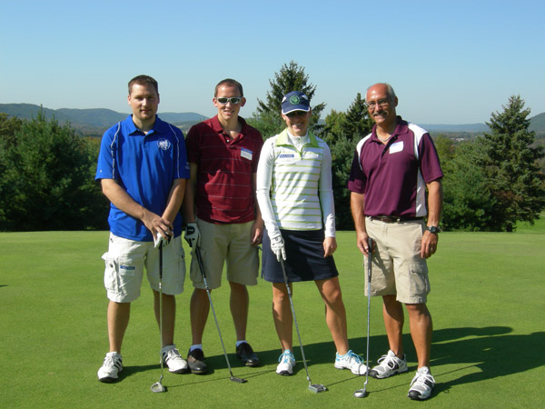 Dan Bennett, the college's information technology security analyst (left), joins his brother, sister and father on the green. His business, Benit Services Inc., sponsored the tournament breakfast.