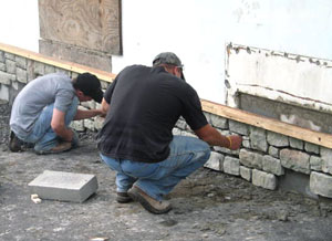 Mountain-stone adornment takes shape at Tech Serve International under the skilled hands of Jude M. Shammo, a carpentry student from Huntingdon Valley (left), and masonry major Eric J. Conti, of Ringtown.