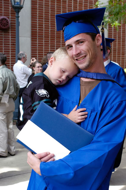 Patrick W. Herr, an emergency medical services graduate, with a tuckered-out well-wisher.